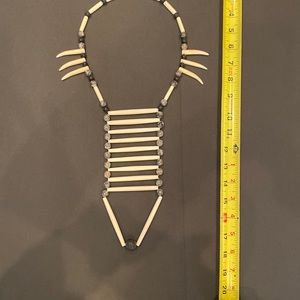 Tribal necklace hand made. Black with ivory colored beads of different shapes